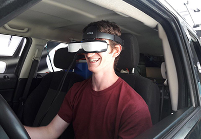 smiling-teen-male-driving-simulator