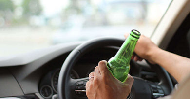 green-beer-bottle-held-while-driving