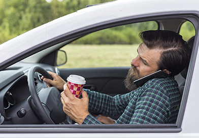 distracted-driving-man-phone-coffee