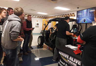 students-gather-round-distracted-driving-simulator